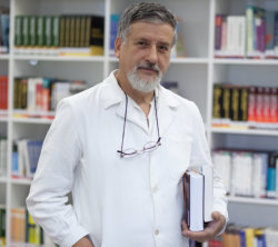 male staff holding book